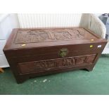 LIFT-TOP CAMPHOR WOOD CHEST HEAVILY CARVED WITH ORIENTAL SCENES