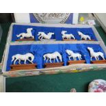 BOXED SET OF EIGHT CARVED BONE MINIATURE HORSES ON WOODEN PLINTHS