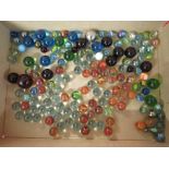 GLASS PEBBLES AND MARBLES CONTAINED IN TIN AND GLASS VASE