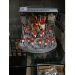 TWELVE CORGI ICON COLLECTABLE FIGURES OF MANCHESTER UNITED PLAYERS (WITH BOXES) ON DISPLAY STAND