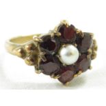 Vintage 9 carat gold ring, a small central pearl surrounded by six garnets, British hallmarks, total