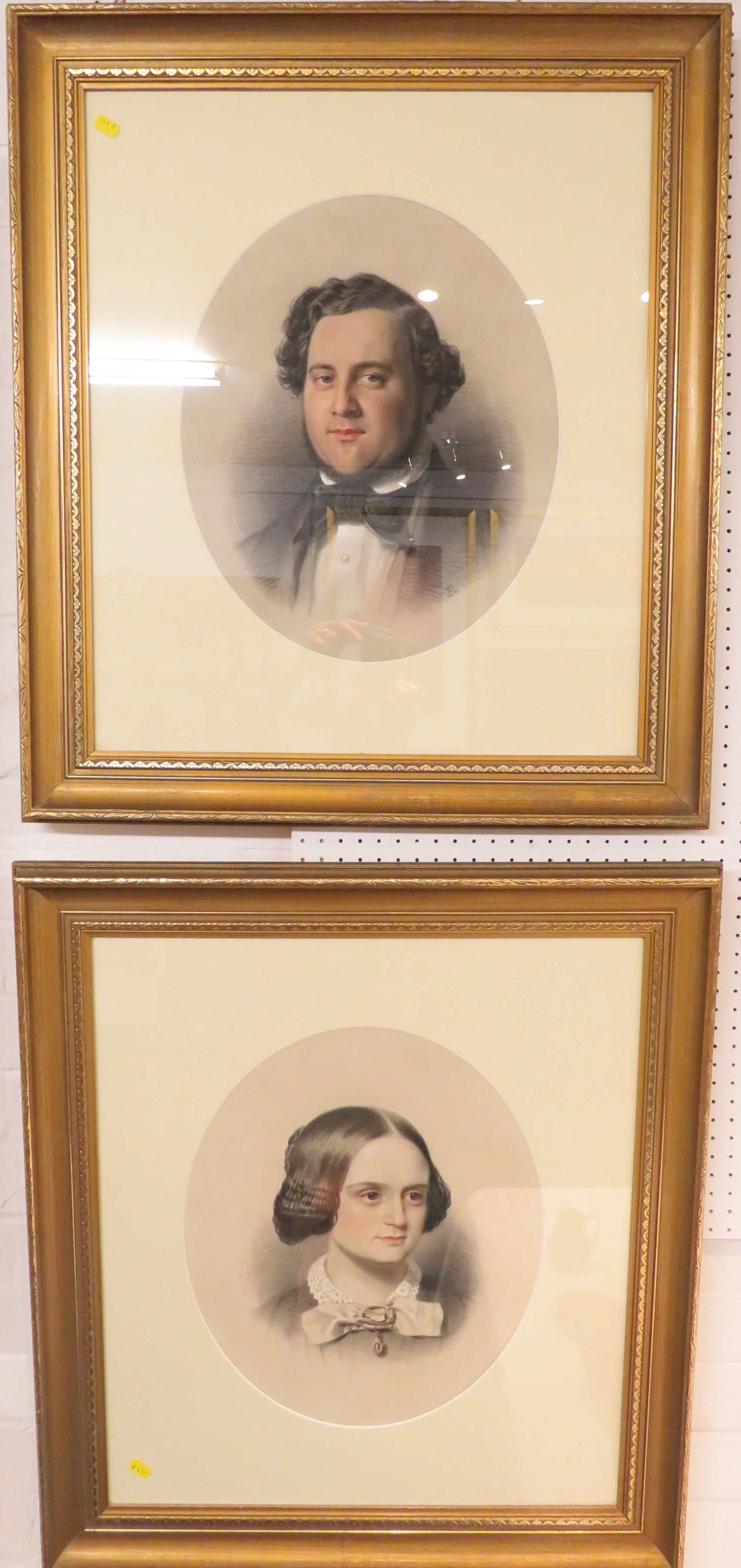 A pair of pastel and chalk head and shoulder portraits of Victorian gentleman and lady,