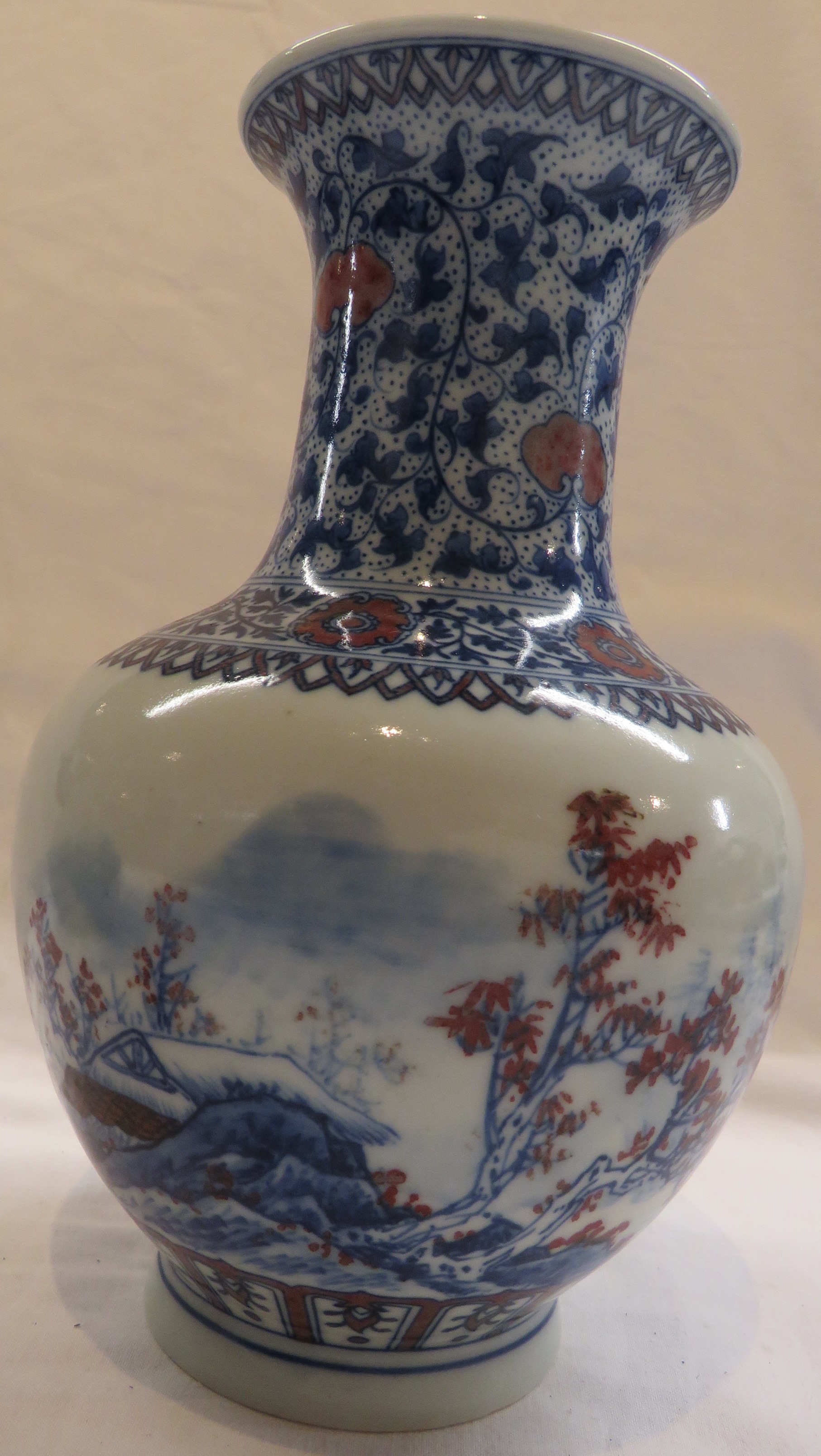 Chinese porcelain bottle vase, painted in underglaze blue and red to the body with landscape with