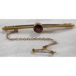 15 carat gold bar brooch set with a faceted red stone (diameter 6.5mm), length of brooch 57mm,