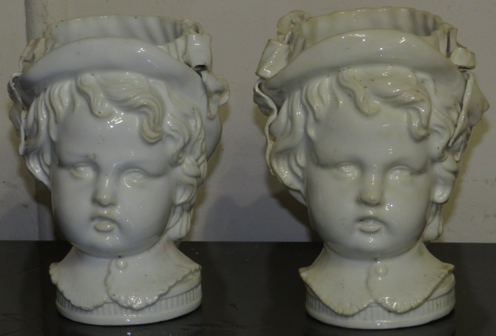 Pair of 19th century blanc de chine vases modelled as infant's heads, perhaps Minton, height 12.5cm