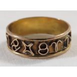 Yellow metal ring set with wirework stylised script and symbols, 1.4g, no assay marks, size K for
