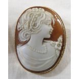Cameo brooch depicting woman in profile wearing flowers and pearls, 9ct gold mount, British assay