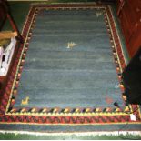 BLUE GROUND PATTERNED FLOOR RUG WITH TASSELED ENDS