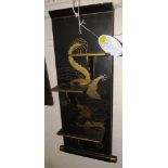 A WALL-HANGING BRACKET WITH THREE FOLDING SHELVES, BLACK LACQUER WITH GILT AND ENAMEL CHINESE DRAGON