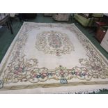 LARGE CREAM GROUND FLORALLY PATTERNED FLOOR RUG WITH TASSELLED ENDS