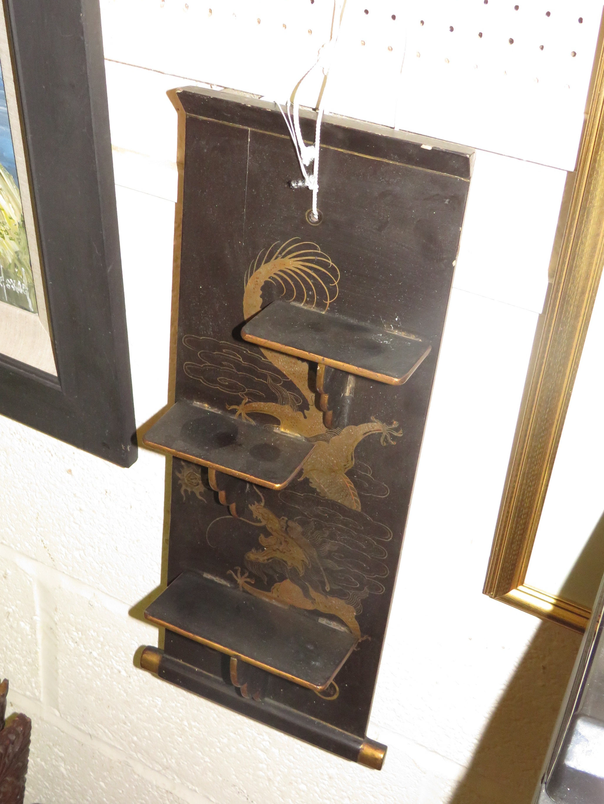 A WALL-HANGING BRACKET WITH THREE FOLDING SHELVES, BLACK LACQUER WITH GILT AND ENAMEL CHINESE DRAGON - Image 2 of 3