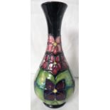 Moorcroft pottery bottle vase, dark green ground with tube lined decoration of stylized square
