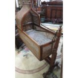 A Bergere cradle on a mahogany baluster turned frame (height 121cm width 44cm length 105cm) - sold