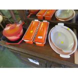 SIX PIECES OF ORANGE LE CREUSET CAST METAL COOKWARE