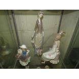 THREE LLADRO FIGURINES INCLUDING SEATED GIRL, GIRL WITH FLOWERS AND LADY WITH DOG (TWO A/F)