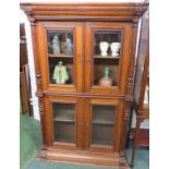 A 19th century oak bookcase, an upper and a lower section each with two glazed doors enclosing