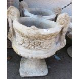 PAIR OF COMPOSITE STONE URNS ON PLINTHS WITH LARGE SCROLLED HANDLES