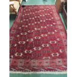 LARGE RED GROUND PATTERNED FLOOR RUG WITH TASSELLED ENDS (APPROXIMATE SIZE 200CM X 300CM)