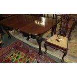 Victorian mahogany extending dining table on cabriole legs, ball and claw feet, and brown china