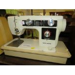 NEW HOME ELECTRIC SEWING MACHINE IN PLASTIC CARRY CASE (A/F)