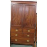 A William IV mahogany and stained pine linen press, the upper section with two doors enclosing two