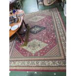 RED GROUND RECTANGULAR RUG WITH THREE MEDALLIONS AND STYLIZED ANIMALS AND FLOWERS