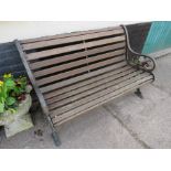 WOODEN SLATTED GARDEN BENCH WITH BLACK PAINTED CAST WROUGHT METAL ENDS