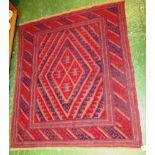 RED AND BLUE GROUND PATTERNED WOVEN RUG WITH TASSELLED ENDS
