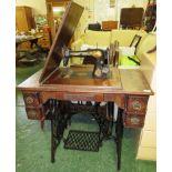 SINGER TREADLE SEWING MACHINE WITH MAHOGANY VENEERED TOP AND FIVE DRAWERS