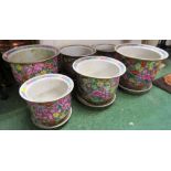 TWO SETS OF THREE GRADUATED PLANTERS WITH SAUCERS DECORATED WITH FLOWERS