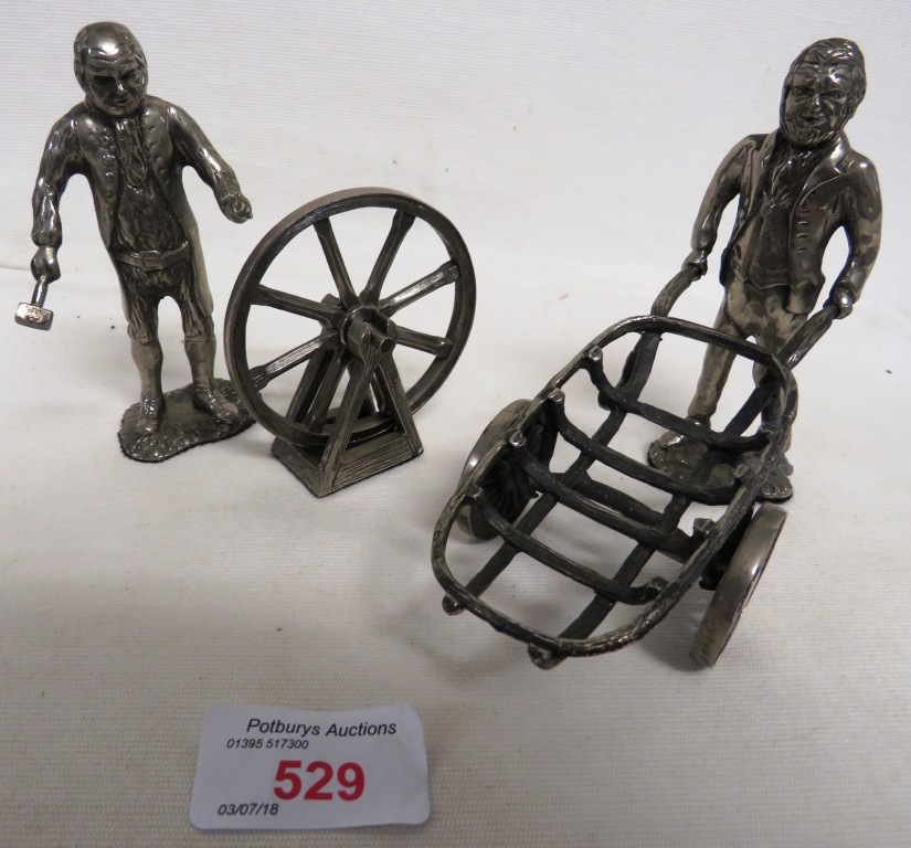 TWO SILVER PLATED FIGURES - MAN WITH CART AND MAN REPAIRING CART WHEEL