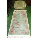 RECTANGULAR EMBOSSED GREEN GROUND FLORAL PATTERNED FLOOR RUG WITH TASSELLED ENDS, TOGETHER WITH D-
