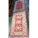 TWO SMALL RECTANGULAR SALMON PINK GROUND FLOOR RUGS, BOTH WITH THREE CENTRAL MEDALLIONS AND