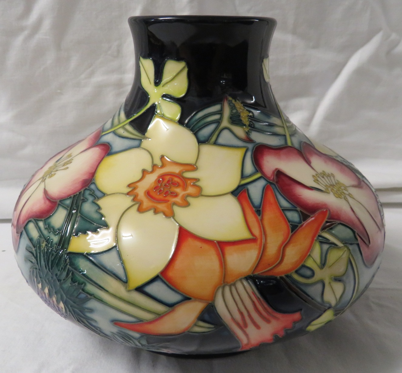 Moorcroft pottery QEII Golden Jubilee large squat vase, dark blue ground, tube lined decoration of