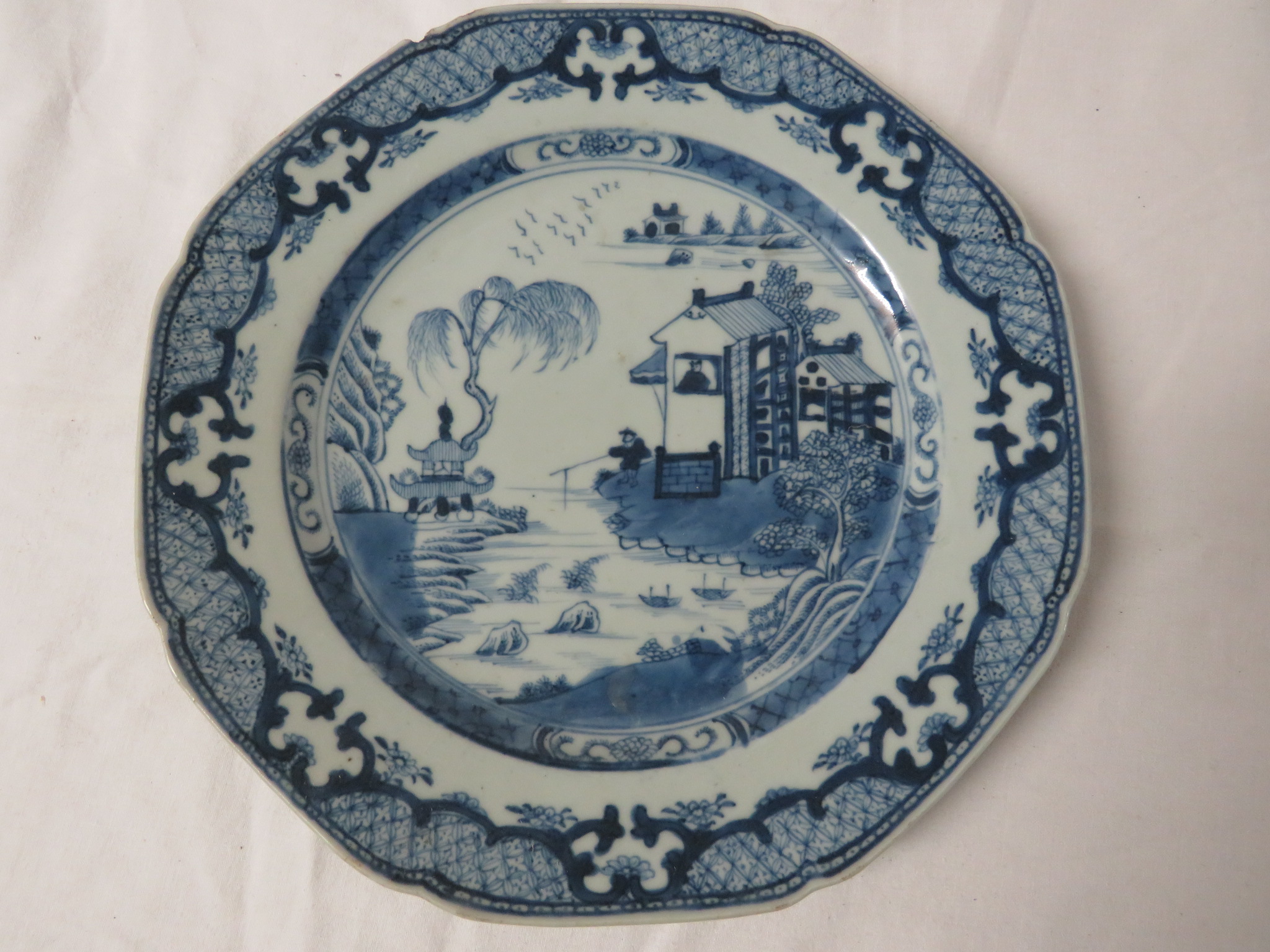 An octagonal Chinese blue and white porcelain plate painted with houses in landscape and a patterned - Image 4 of 5