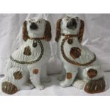 A pair of Staffordshire style pottery spaniel dogs, 23cm