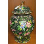 A large Chinese porcelain famille noire lidded vase, enamelled with pink, blue and yellow flowers