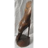 A finely carved figure of a bird with elongated tail eating lizard, perhaps Polynesian, height 28cm