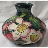 Moorcroft pottery Accolade three star members vase of squat form, dark blue/green ground, tube lined