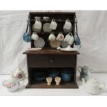 A dolls oak dresser (height 38cm, width 26.5cm) with a small assortment of dolls china and enamel