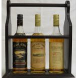 Three bottles of whisky in a wooden holder - Blair Athol single malt, aged 8 years, 75cl; the