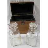 A mid 19th century decanter box with two cut glass decanters, light wood with ebonised edging, brass