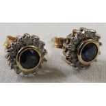 Pair of 9-carat gold earrings each set with a round cut sapphire (about 4mm diameter) within a