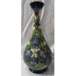 Moorcroft Pottery Wolfsbane bottle vase, cream ground, dark blue at neck and foot, tube lined