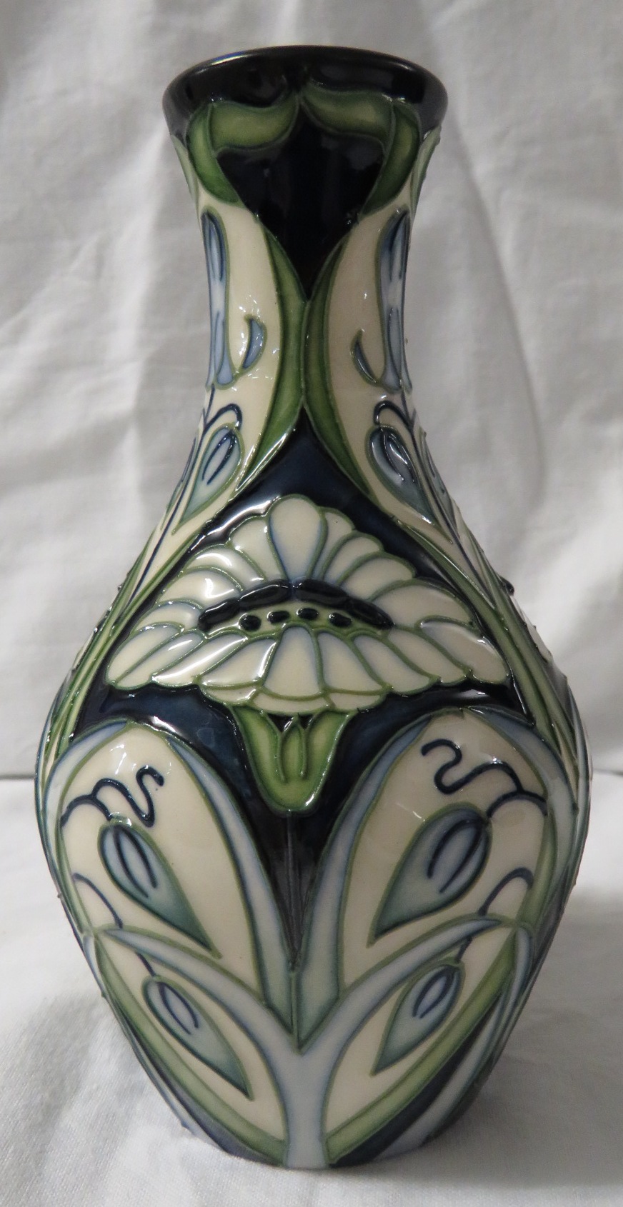 Moorcroft pottery Rain Daisy one star members vase of baluster form, dark blue ground with tube