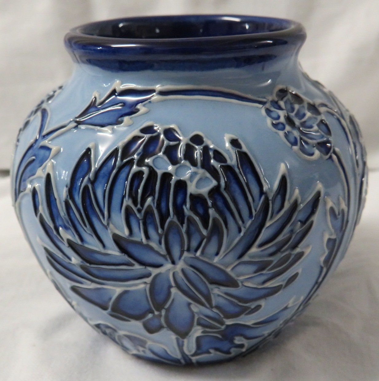 Moorcroft pottery small ovoid vase in the style of Macintyre Florian ware, pale blue with tube lined