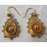 Pair of yellow metal hollow earrings of teardrop shape with repousse florets and bead work, together