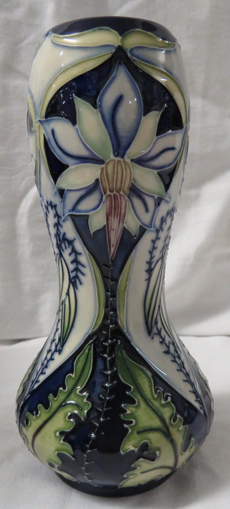 Moorcroft pottery Meadow Star baluster vase with bulbous neck, dark blue ground, tube lined