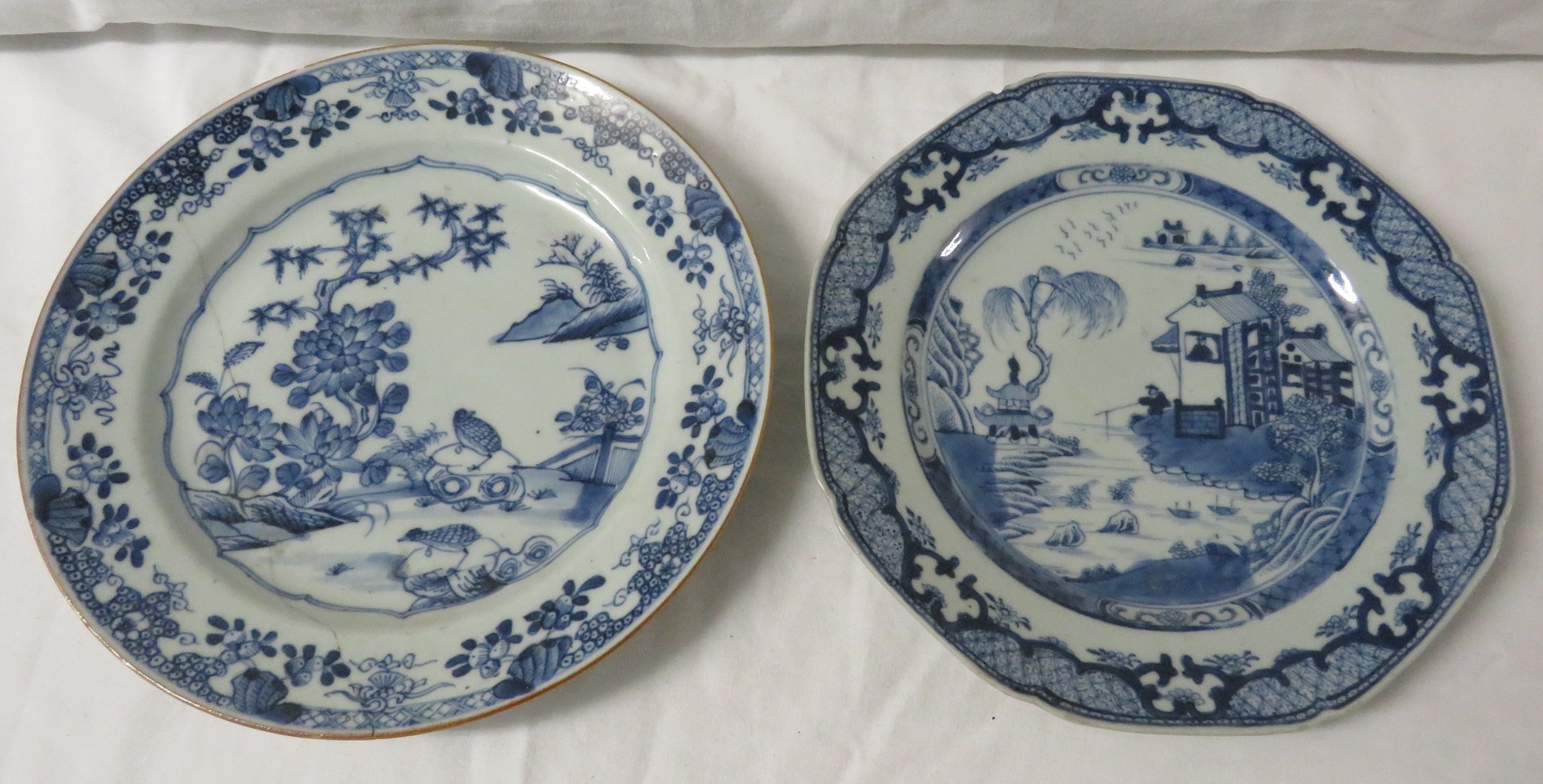 An octagonal Chinese blue and white porcelain plate painted with houses in landscape and a patterned