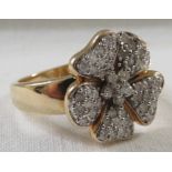 9-carat gold ring with a cluster of very small brilliant cut diamonds set as a five-petal flower,